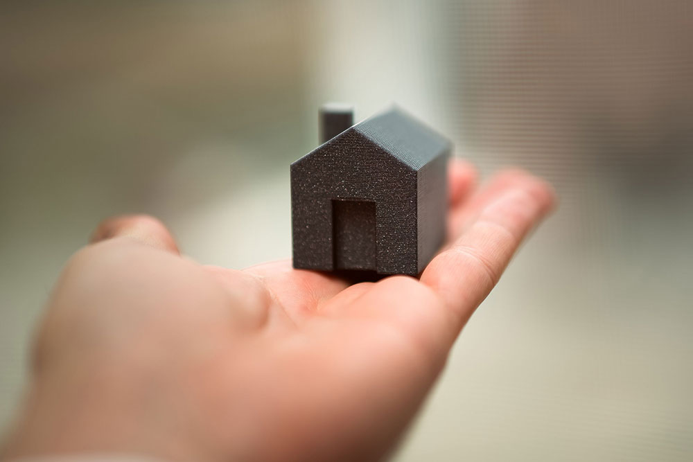 An image of a house in a hand.