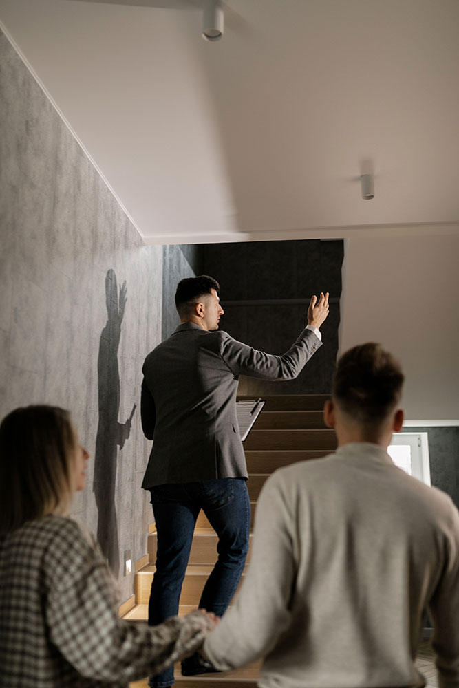 An estate agent showing people around a property.